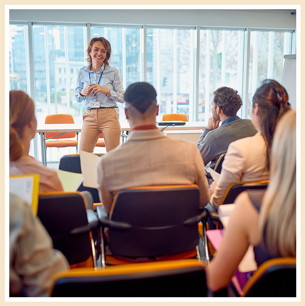 A woman standing in front of a group of people.