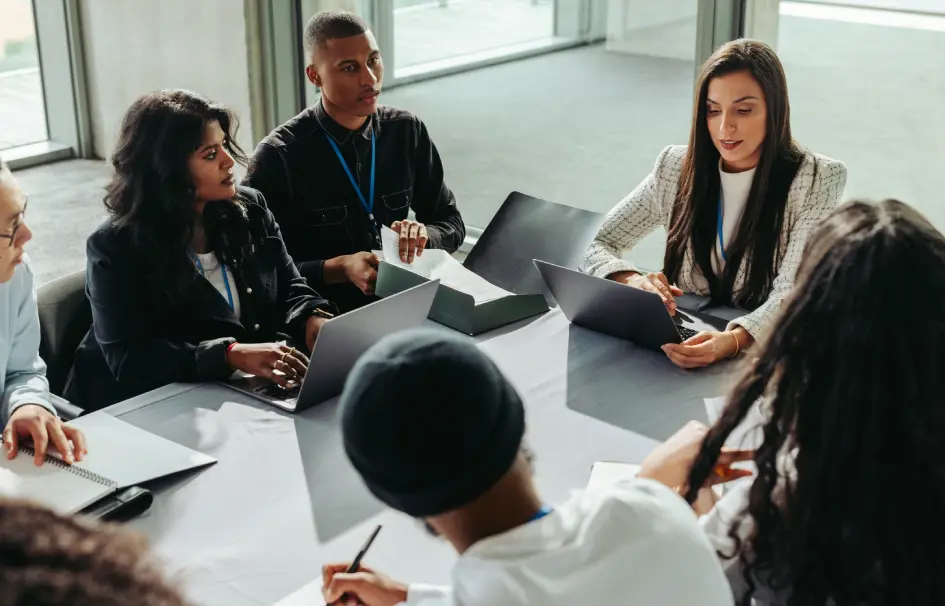 A group of people sitting around a table.