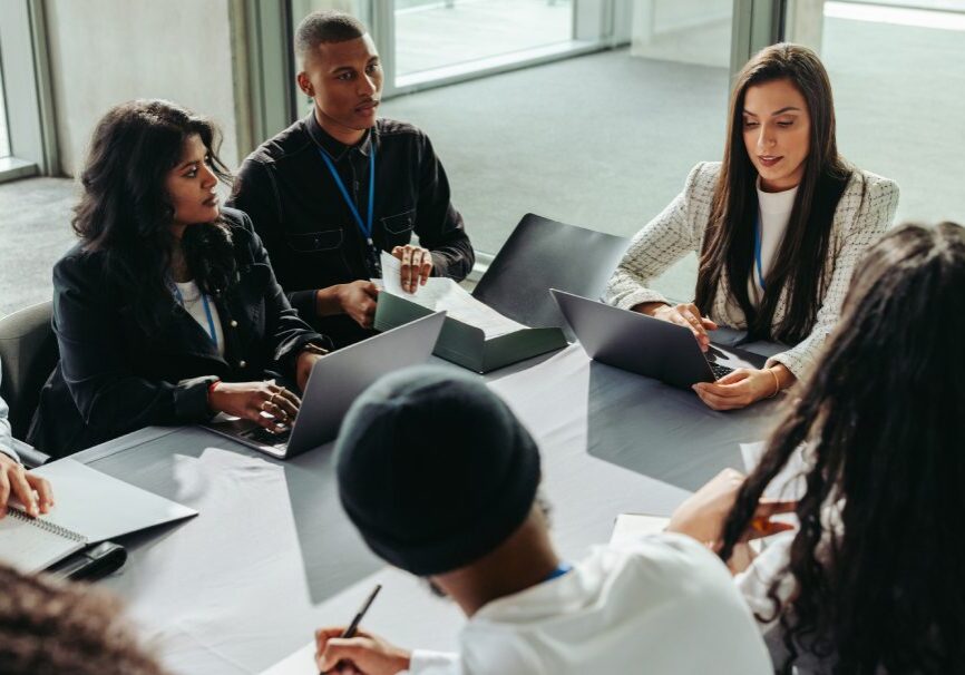 A group of people sitting around a table.